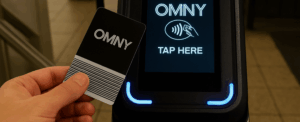 Hand using OMNY tap to pay